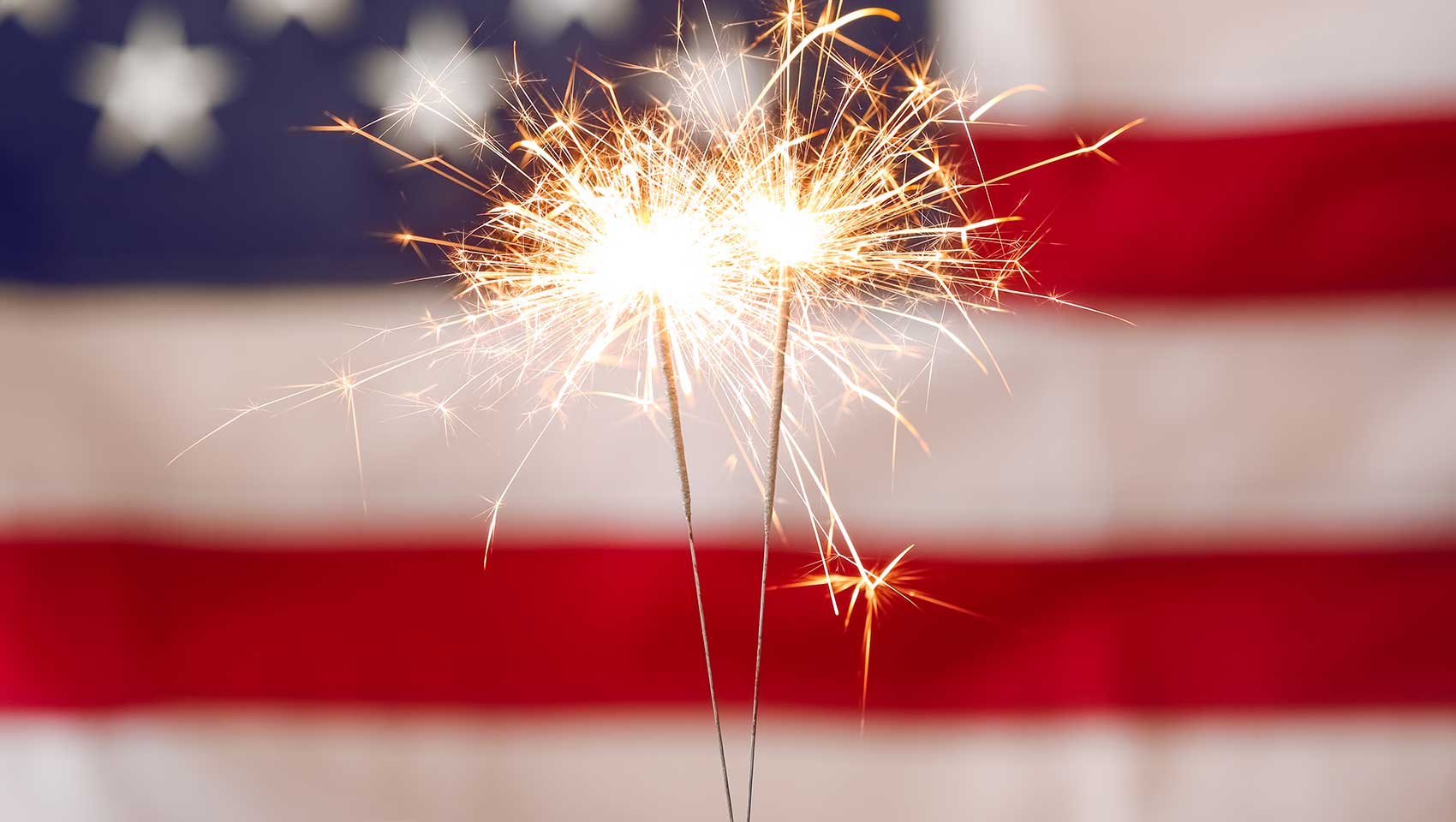 Sparklers in front of American Flag
