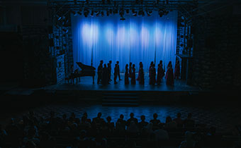 silhouette choir getting ready on stage