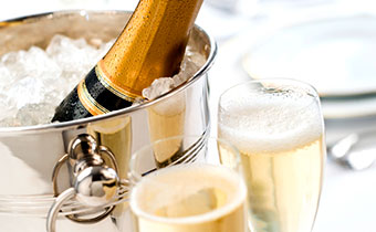 champagne glasses and champagne bottle in bucket of ice