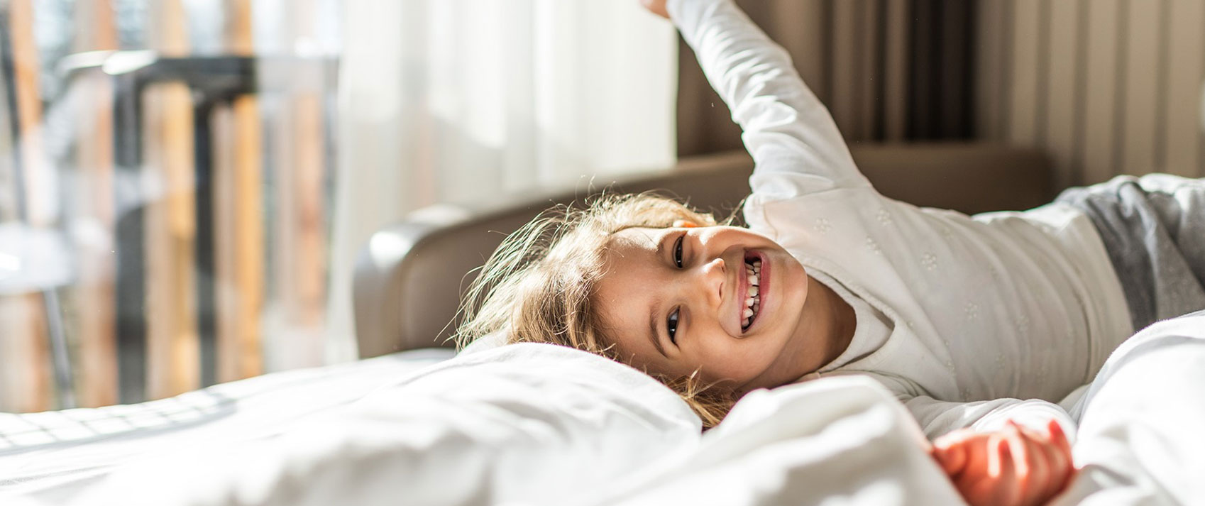 child on hotel bed